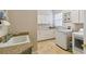 Laundry room with washer, dryer, cabinets, and utility sink at 203 Escondido Ct, Poinciana, FL 34759