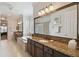 Spa-like bathroom featuring a soaking tub, double vanity, and glass block accents at 203 Escondido Ct, Poinciana, FL 34759
