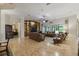 Spacious living room with built-in shelving, leather sofas, and a view of the lanai at 203 Escondido Ct, Poinciana, FL 34759