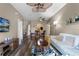 Spacious living room, open floor plan, hardwood floors, and access to dining area and kitchen at 7671 Comrow St # 202, Kissimmee, FL 34747