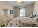 Comfortable bedroom with a queen bed, dresser, and large window at 7671 Comrow St # 202, Kissimmee, FL 34747