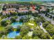Aerial view of condo building, tennis courts, and playground at 7671 Comrow St # 202, Kissimmee, FL 34747