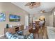 Open living area with hardwood floors, comfortable seating and access to kitchen at 7671 Comrow St # 202, Kissimmee, FL 34747