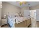 Spacious bedroom with a queen bed, light walls, and ensuite bathroom access at 7671 Comrow St # 202, Kissimmee, FL 34747