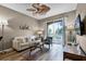 Relaxing living room with light walls, comfy sofa, and access to a balcony at 7671 Comrow St # 202, Kissimmee, FL 34747