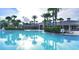 Resort-style pool with lounge chairs and palm trees at 7671 Comrow St # 202, Kissimmee, FL 34747