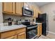 Modern kitchen featuring stainless steel appliances and wood cabinetry at 7671 Comrow St # 202, Kissimmee, FL 34747