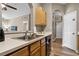 Kitchen with double sink, wood cabinets, and access to hallway at 7671 Comrow St # 202, Kissimmee, FL 34747