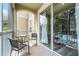 Screened balcony with table and chairs at 7671 Comrow St # 202, Kissimmee, FL 34747