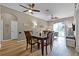 Bright dining area with table and chairs, hardwood floors, and access to living room at 7671 Comrow St # 202, Kissimmee, FL 34747
