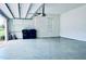 Garage with epoxy floor, utility hookups, and storage space at 10091 Austrina Oak Loop, Winter Garden, FL 34787