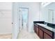 Bathroom with vanity, granite countertop, and access to hallway at 10091 Austrina Oak Loop, Winter Garden, FL 34787