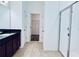 Bathroom with shower, double vanity, and walk-in closet at 10091 Austrina Oak Loop, Winter Garden, FL 34787