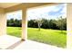 Covered patio overlooking a lush green lawn at 10091 Austrina Oak Loop, Winter Garden, FL 34787