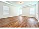 Spacious bedroom with wood-look floors and multiple windows at 10091 Austrina Oak Loop, Winter Garden, FL 34787