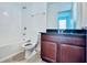 Bathroom boasts granite countertop vanity and tub at 10091 Austrina Oak Loop, Winter Garden, FL 34787