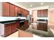 Modern kitchen with dark wood cabinets and granite countertops at 10091 Austrina Oak Loop, Winter Garden, FL 34787
