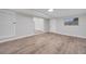 Open living room with wood-look floors and access to other rooms at 1318 Terre Cia Ave, Orlando, FL 32807