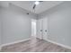 Well-lit bedroom with ceiling fan, wood floors, and double doors at 1318 Terre Cia Ave, Orlando, FL 32807