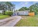 Newly renovated home with gray exterior and driveway at 1318 Terre Cia Ave, Orlando, FL 32807