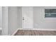 Front entry with white door and wood-look floors at 1318 Terre Cia Ave, Orlando, FL 32807