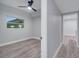 Bright bedroom with ceiling fan, wood-look floors, and window at 1318 Terre Cia Ave, Orlando, FL 32807