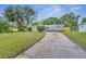Newly renovated home with gray exterior and driveway at 1318 Terre Cia Ave, Orlando, FL 32807