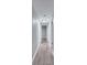 Long hallway with wood-look flooring and neutral walls at 1318 Terre Cia Ave, Orlando, FL 32807