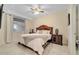 Bright bedroom with a king-size bed, nightstands, and ceiling fan at 4721 Clock Tower Dr # 302, Kissimmee, FL 34746
