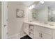 Double vanity bathroom with a large mirror and plenty of storage at 4721 Clock Tower Dr # 302, Kissimmee, FL 34746
