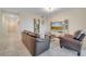 Comfortable living room with leather furniture and a large TV at 4721 Clock Tower Dr # 302, Kissimmee, FL 34746
