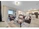 Spacious living room with a leather sofa and large windows at 4721 Clock Tower Dr # 302, Kissimmee, FL 34746