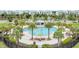 Community pool with palm trees and lounge chairs at 4721 Clock Tower Dr # 302, Kissimmee, FL 34746
