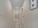 Well-lit hallway with access to bedrooms and other rooms at 4721 Clock Tower Dr # 302, Kissimmee, FL 34746