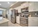 Modern kitchen with stainless steel appliances and white cabinets at 4721 Clock Tower Dr # 302, Kissimmee, FL 34746