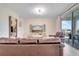 Bright living room with brown leather sofa and large TV at 4721 Clock Tower Dr # 302, Kissimmee, FL 34746