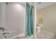 Bathroom with tub shower, toilet and teal shower curtain at 4721 Clock Tower Dr # 302, Kissimmee, FL 34746