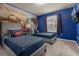 Bedroom with twin beds and Cars themed wall at 3209 Lilac Way, Davenport, FL 33897