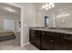 Double vanity bathroom with granite countertops and a view to a bedroom at 3209 Lilac Way, Davenport, FL 33897
