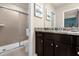 Bathroom with shower, granite countertop and dark brown cabinets at 3209 Lilac Way, Davenport, FL 33897
