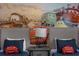 Twin beds in a themed bedroom with Cars wall art and matching decor at 3209 Lilac Way, Davenport, FL 33897