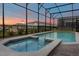Enclosed pool and spa area with outdoor lighting at 3209 Lilac Way, Davenport, FL 33897