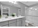 Modern bathroom with double vanity and a walk-in shower at 4716 Terra Esmeralda Dr, Kissimmee, FL 34746