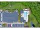 Aerial view showing townhouses, pool, and a pond in a wooded area at 4716 Terra Esmeralda Dr, Kissimmee, FL 34746