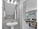 Powder room with pedestal sink and mirror at 4716 Terra Esmeralda Dr, Kissimmee, FL 34746