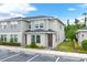 Two-story townhouse with gray siding and a brown door, with parking in front at 4716 Terra Esmeralda Dr, Kissimmee, FL 34746