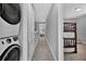 Clean hallway with laundry area and access to bedrooms at 4716 Terra Esmeralda Dr, Kissimmee, FL 34746