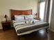 Spacious bedroom with a king-size bed and wood floors at 3100 Parkway Blvd # 611, Kissimmee, FL 34747