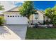 Attractive single-story home with a well-maintained lawn and a two-car garage at 162 Seneca Point Trl, Kissimmee, FL 34746