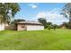 Detached garage with solar panels and fenced yard at 50 2Nd St, Saint Cloud, FL 34769